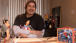 A man sitting in front of a desk with toys.