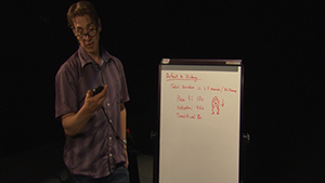 A man standing in front of a whiteboard.
