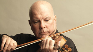 A bald man playing a violin on a gray background.