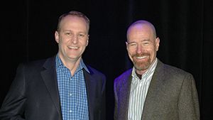 Two men standing next to each other at an event.