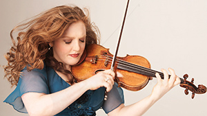 A woman in a blue dress playing a violin.