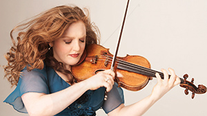 A woman in a blue dress playing a violin.