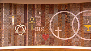 A wooden wall with a cross, a cross, a cross, and a cross.