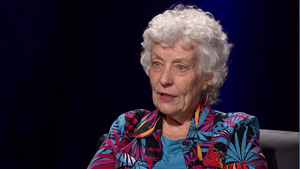 An older woman sitting in a chair.