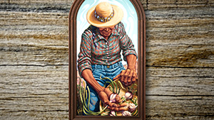 A wooden frame with a painting of a farmer.