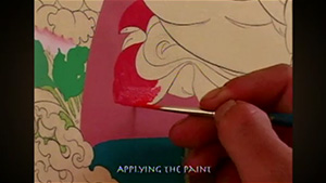 A person is painting a picture of a santa claus.