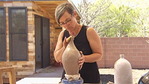 A woman is making a vase.