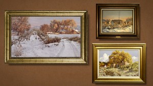 Three framed paintings on a brown wall.
