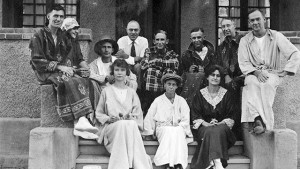 A group of people sitting on the steps of a building.