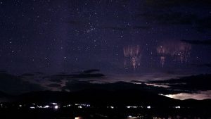 An image of a starry sky over a city.