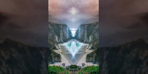 A photo of a cliff with a waterfall in the background.