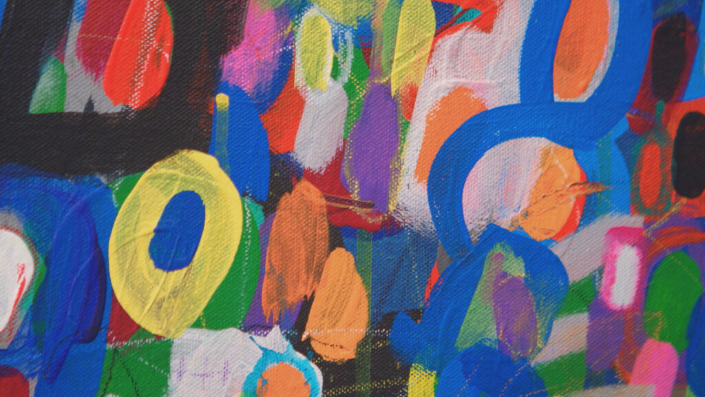 An abstract painting of lots of circle shapes in a variety of colors