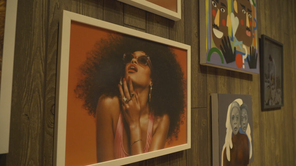 A wall featuring Mickalene Thomas' art depicting women 