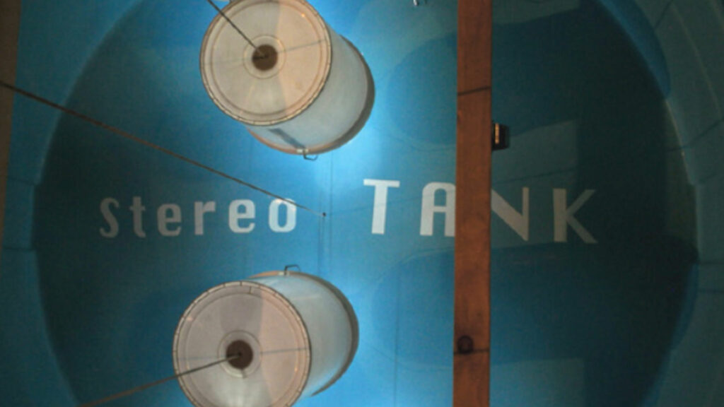 A blue background with "Stereo Tank" printed on it with two white circular tanks on it