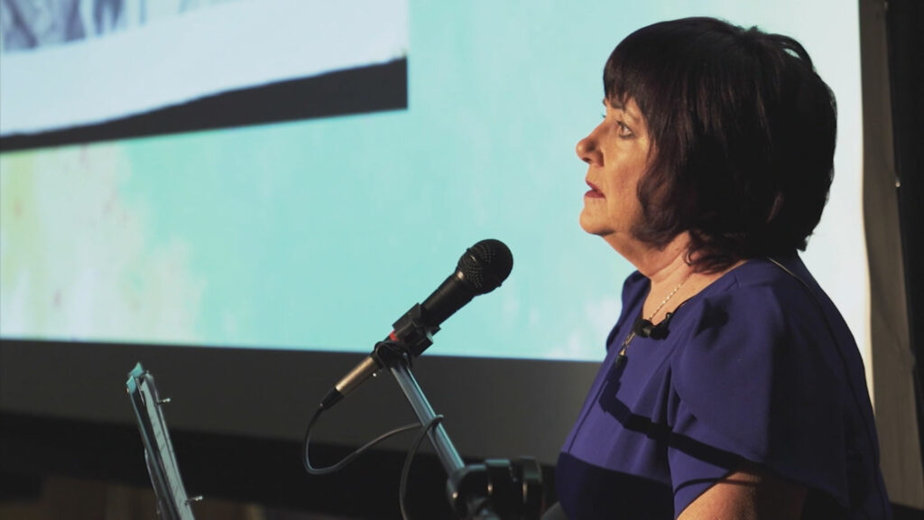 A person giving a speech into a microphone