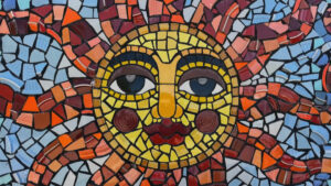 A mosaic of the sun with a face.