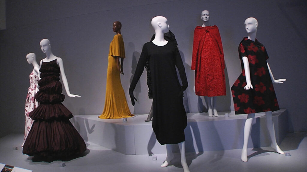 Multiple mannequins wearing dresses made by women.