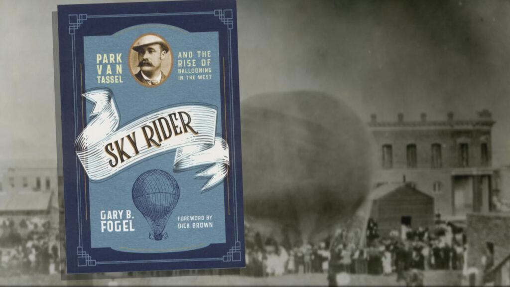 A black and white photograph of a hot air balloon with the cover of Gary B Fogel's Book "Sky Rider" superimposed.