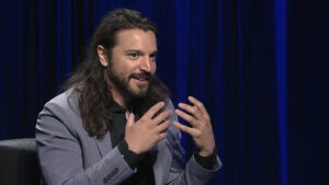 Portrait of Dmitri Brown talking with his hands.