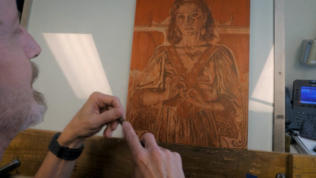 Mark Sisson working on a print of a woman.