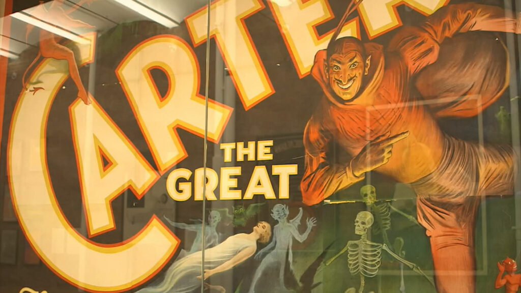 The window of the Poster House museum with a movie giant poster being displayed.