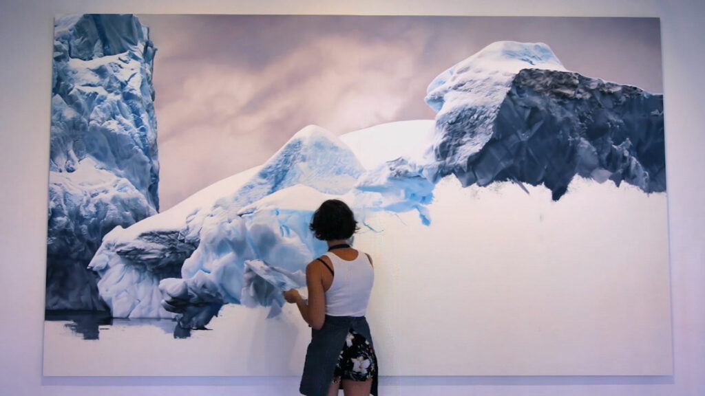 Zaria Forman painting a glacier on a large canvas.