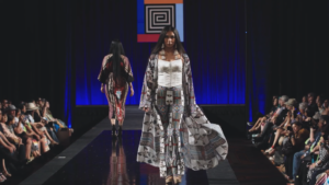 A model walking down a runway wearing Amber Dawn Bear Robe's designs.