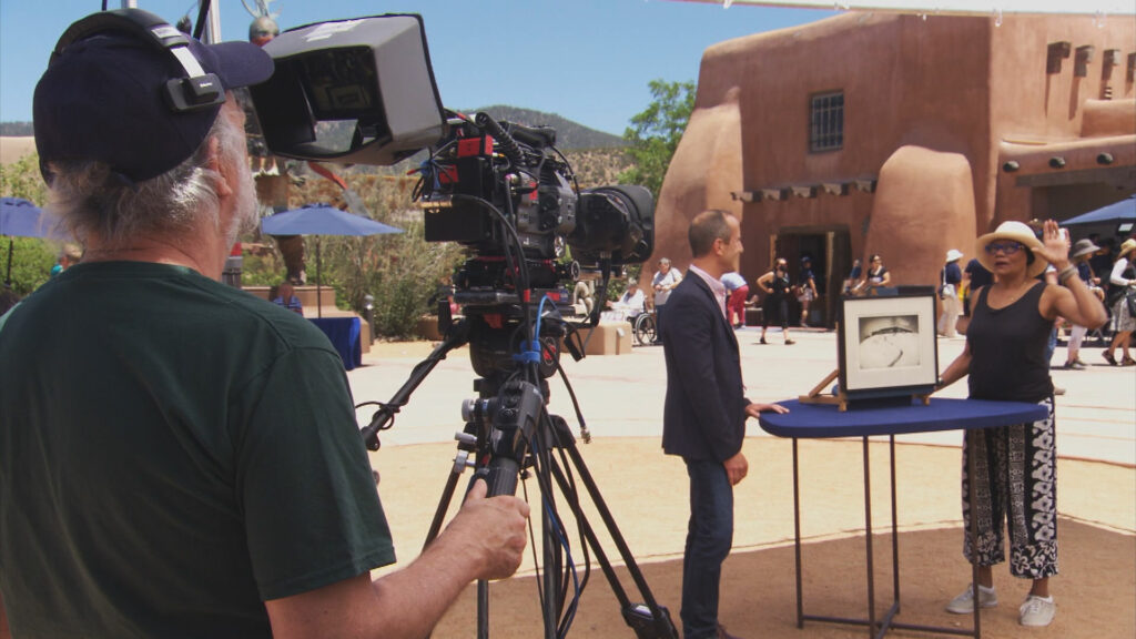 A cameraman recording an appraisal at the Antiques Roadshow event in Santa Fe.