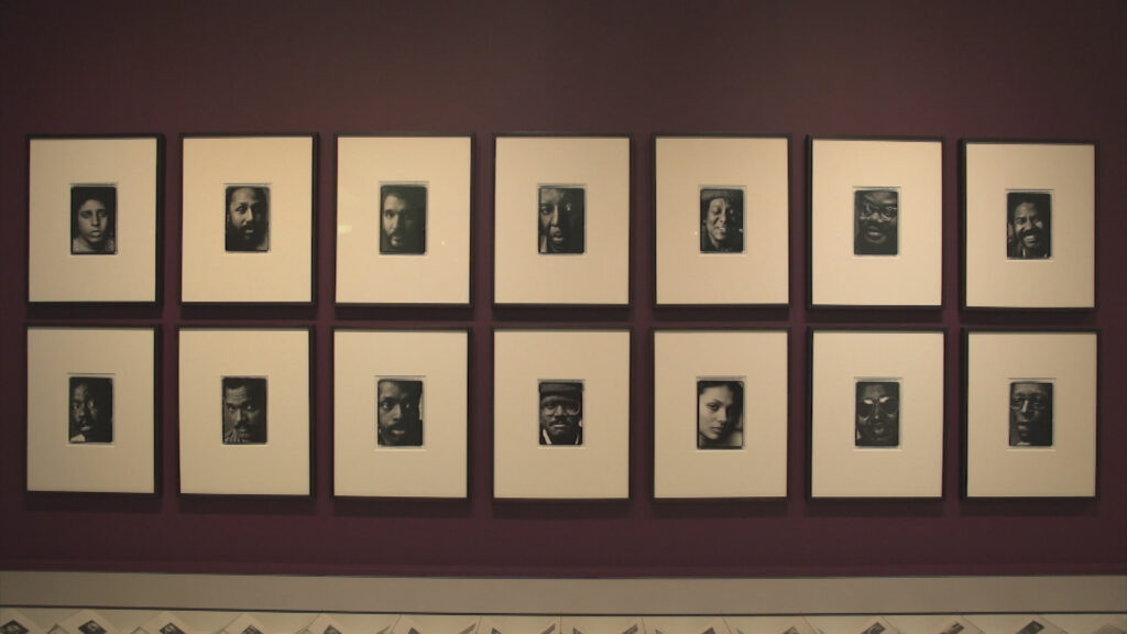 An art piece installation featuring 14 different portraits.