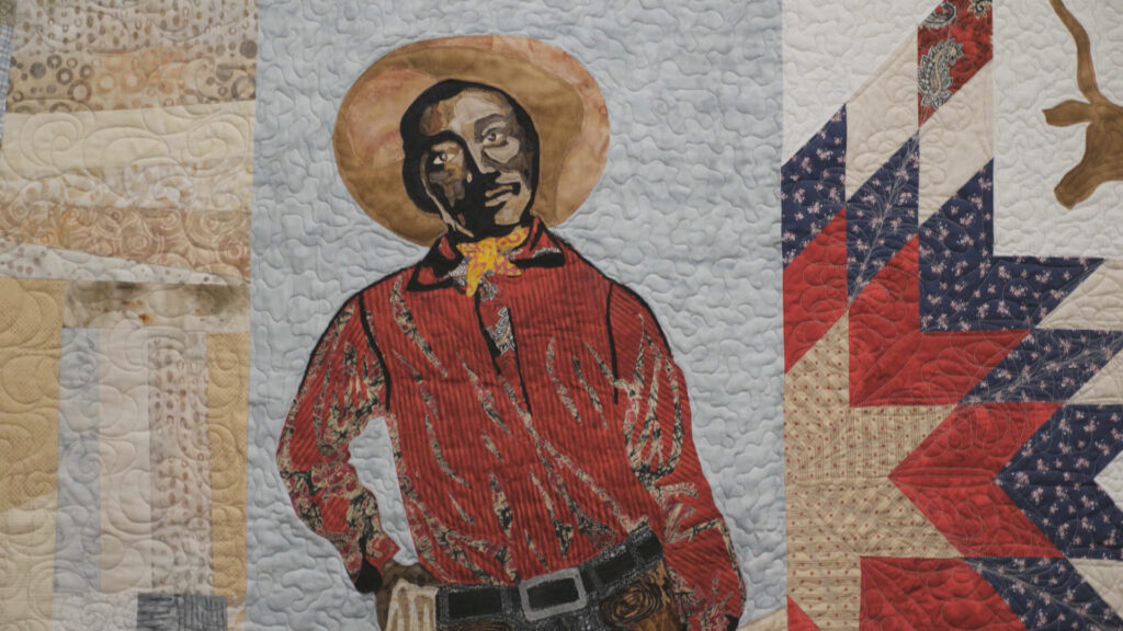 A quilt with a picture of a cowboy on it.