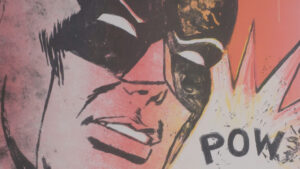 A comic book illustration of batman with the word pow.