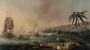 A historical painting depicting ships near a tropical shore with people loading and unloading goods. Palm trees and hills are visible in the background under a cloudy sky.