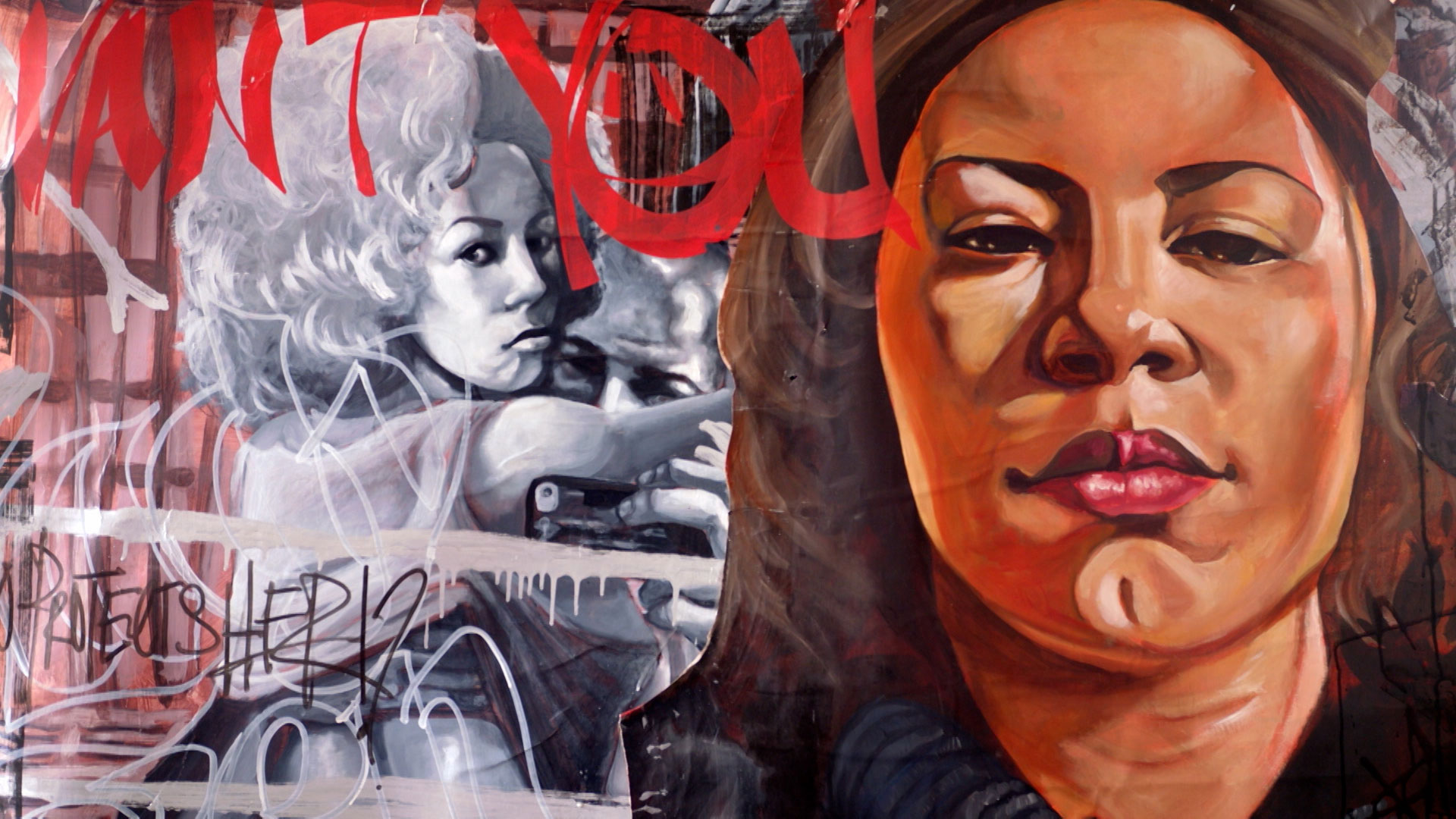 A mural features a detailed portrait of a woman in warm tones on the right and a grayscale image of two people taking a selfie on the left, overlaid with graffiti and red text.