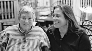 A woman and a woman smiling.
