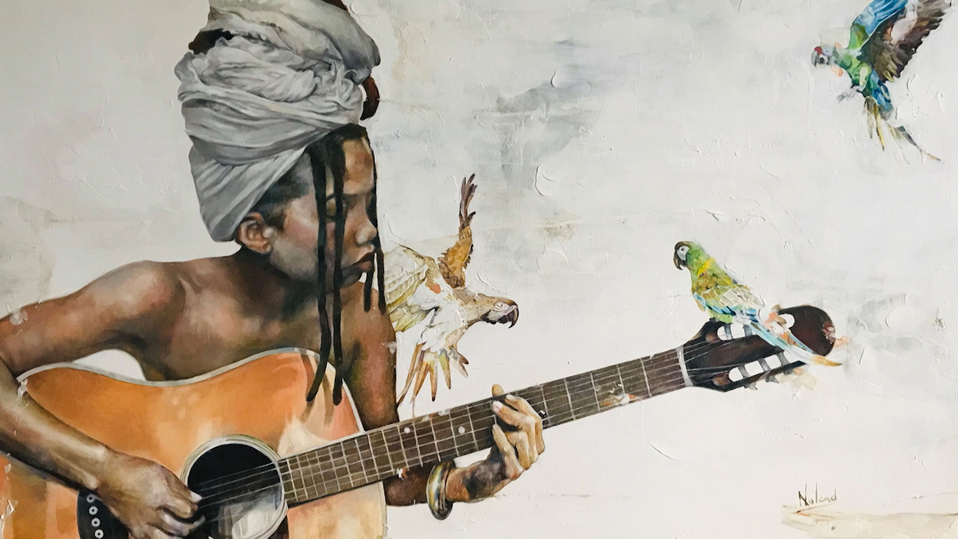 A person with a headwrap plays an acoustic guitar surrounded by colorful parrots, with a light, abstract background.