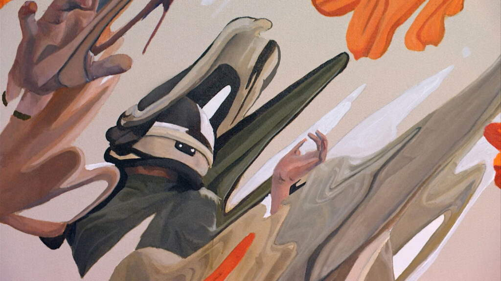 Abstract painting of a person in a helmet with outstretched arms, surrounded by orange and beige swirling shapes.