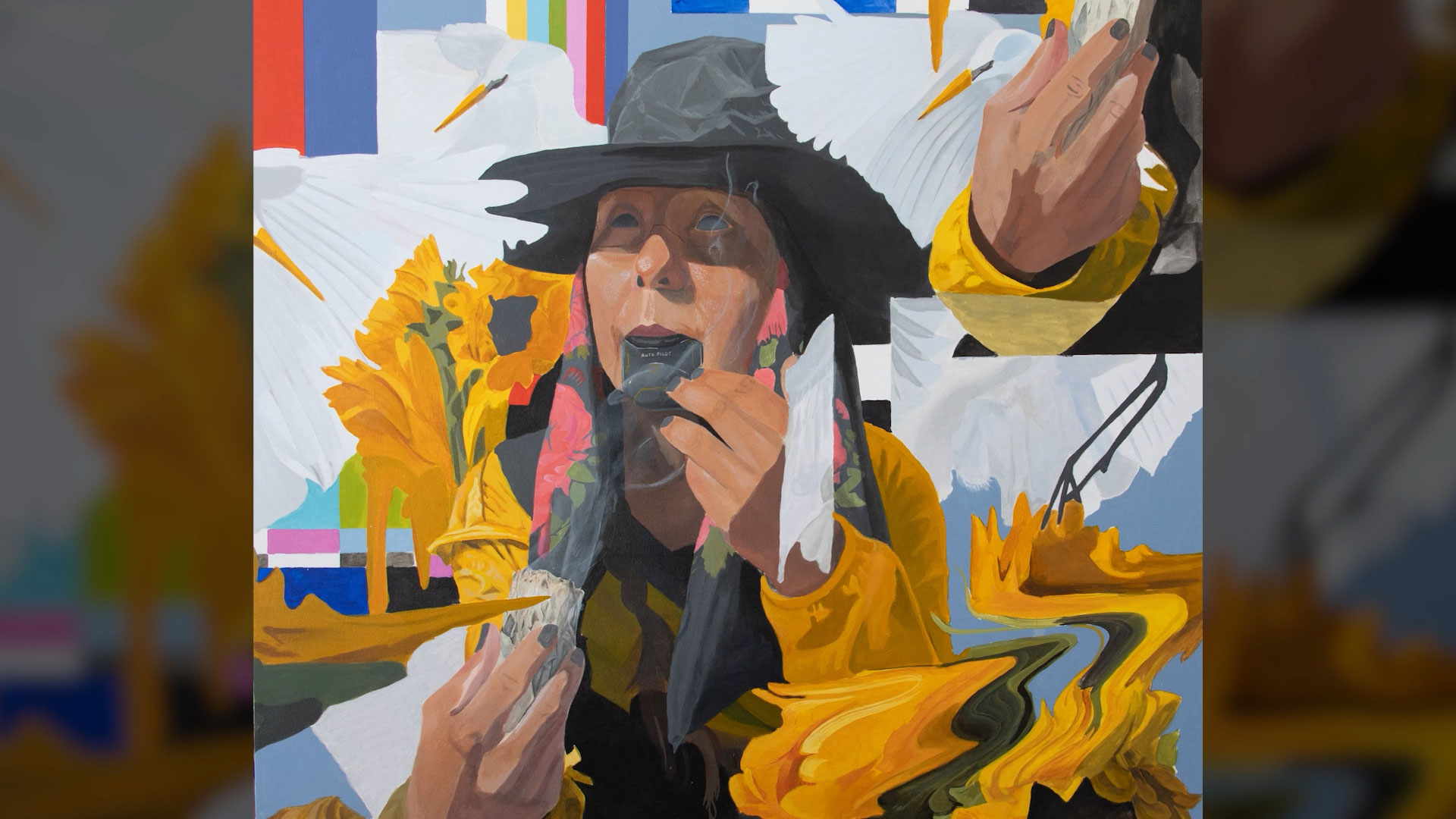 A person in a black hat and yellow clothing applies lipstick, holding a mirror, with abstract, colorful, distorted background elements.