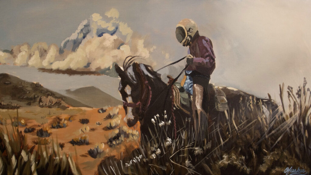 A person wearing a helmet and shorts rides a horse through a dry, grassy landscape with mountains and clouds in the background.