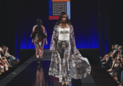 A model walking down a runway wearing Amber Dawn Bear Robe's designs.