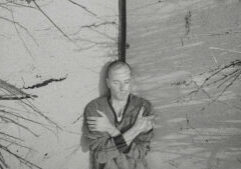 A man leaning against a wall.