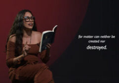 A woman in glasses and a brown outfit reads from a book, gesturing with her hand. White text beside her reads, "for matter can neither be created nor destroyed.