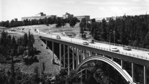 Sixty's vintage vehicles cross Los Alamos Canyon via the LA Bridge, also known as the Omega bridge