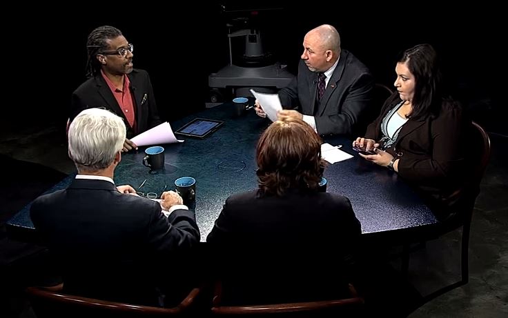 A group of people sitting around a table.