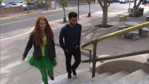 A man and a woman walking down a set of stairs.