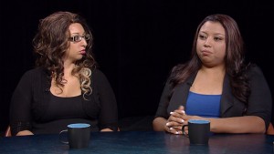 Two women sitting at a table talking.