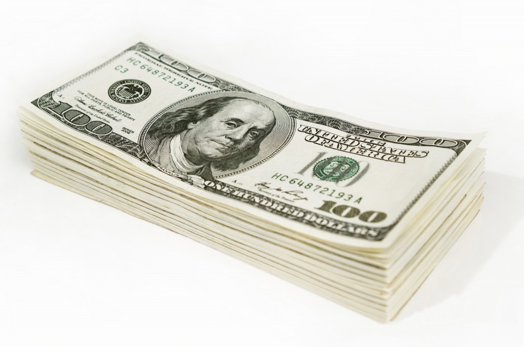 A stack of 100 dollar bills on a white background.