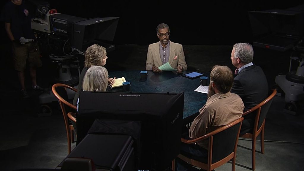 A group of people sitting around a table.