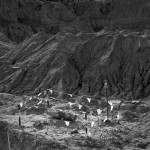 A black and white photo of a dirt hill.