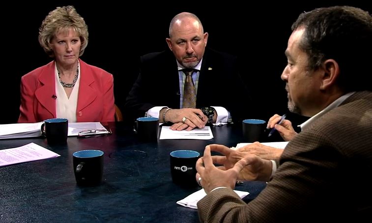 A group of people sitting around a table talking.