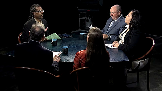 A group of people sitting around a table.
